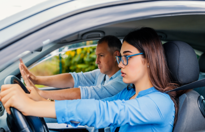 Driving instructor helping a student prepare for a road test